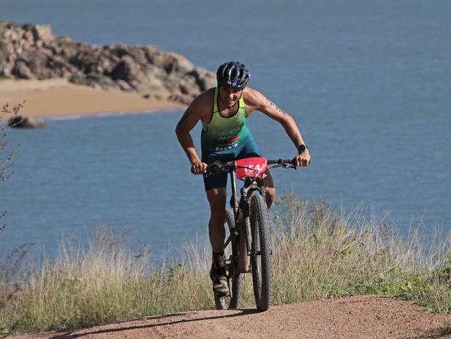 Australia's Tom Fisher powers up the hill away from Shelly Beach during the Elite Cross Duathlon World championships in Townsville. Picture: Stephen Harman.