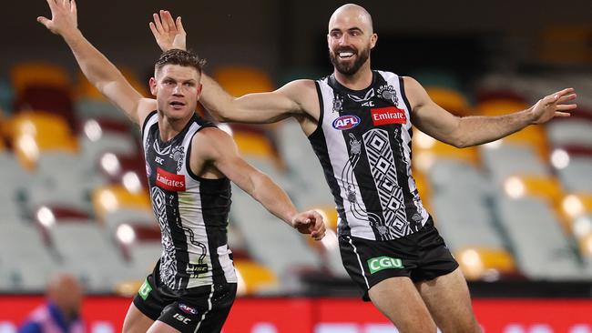 Taylor Adams and Steele Sidebottom celebrate a Collingwood goal against North Melbourne. Picture: Michael Klein