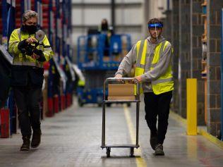 Doses of the Pfizer/BioNTech coronavirus vaccine, which are being stored at a secure location in the Midlands England, are taken from cold storage to waiting transit ahead of distribution to the hundreds of the NHS Covid-19 vaccination centres run by local doctors opening across England. (Photo by Jacob King)