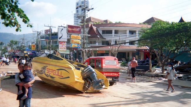 A boat washed up onto main street of Phuket. Picture: Stephen Carroll.