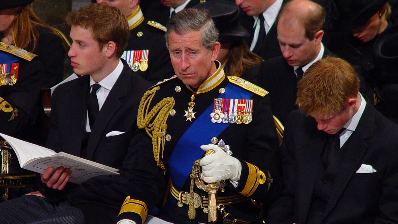 The Prince of Wales in military uniform, flanked by his sons, Prince William (left) and Prince Harry, at the Queen Mother’s funeral in 2002. Picture: AFP