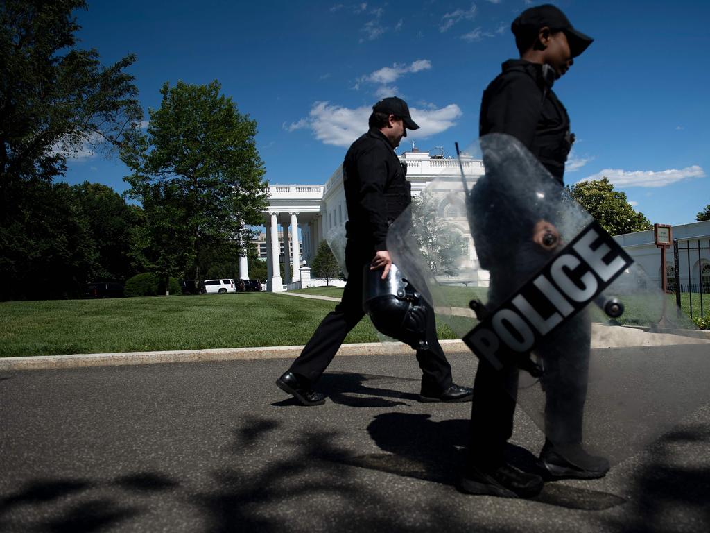 Members of the Secret Service walk past the White House. Picture: Brendan Smialowski / AFP