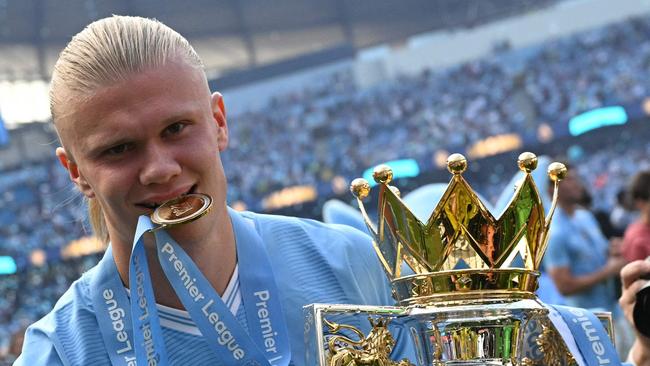 (FILES) Manchester City's Norwegian striker #09 Erling Haaland poses with the Premier League trophy after the presentation ceremony following the English Premier League football match between Manchester City and West Ham United at the Etihad Stadium in Manchester, north west England, on May 19, 2024. Erling Haaland has signed a 10-year contract that will keep him at the Etihad Stadium until 2034, the club announced Friday January 17. (Photo by Oli SCARFF / AFP) / RESTRICTED TO EDITORIAL USE. No use with unauthorized audio, video, data, fixture lists, club/league logos or 'live' services. Online in-match use limited to 120 images. An additional 40 images may be used in extra time. No video emulation. Social media in-match use limited to 120 images. An additional 40 images may be used in extra time. No use in betting publications, games or single club/league/player publications. /