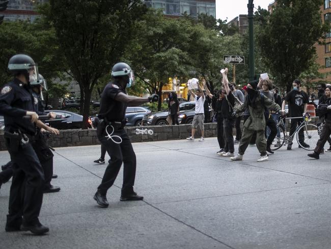 Police advance to arrest protesters refusing to get off the streets during an imposed curfew while marching in a solidarity rally in New York. Picture: AP