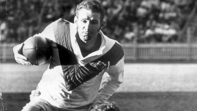 Graeme Langlands (ball) tackled by Barry 'Bunny' Reilly during St George v Easts first grade RL game in Sydney, during early 1970s.