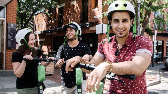 Natasha Taylor of Hallett Cove, Akram and Ayman Kasim of Woodville riding the Lime Scooters for the first time in Adelaide. Picture: AAP Image/ Morgan Sette