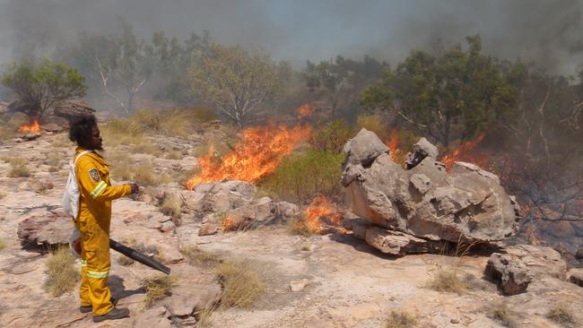 Warddeken indigenous land ranger, Rodney Naborlhborlh carries out controlled burning to reduce weeds in East Arnhem land.