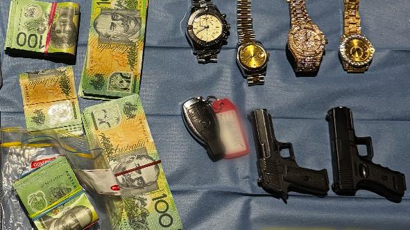 More than $55,000 in cash, a baton, two more replica firearms, 213 grams of meth, 19.5 grams of cocaine, 82 grams of cannabis and 29 grams of ketamine were found. Photo: NSW Police.