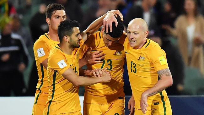 Tomi Juric, Aaron Mooy and Tom Rogic of Australia celebrate.