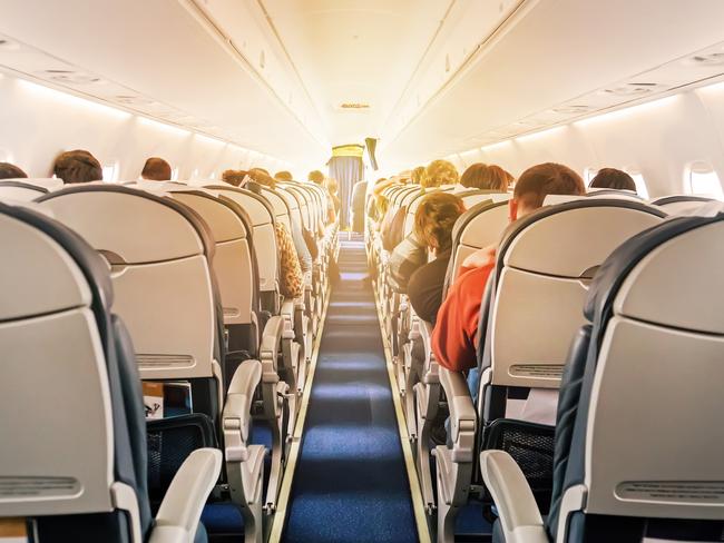 Commercial aircraft cabin with rows of seats down the aisle. morning light in the salon of the airliner. economy class. Picture: iStockglobal roaming, Dilvin yasa, Escape