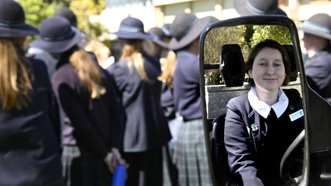 Olivia Holgate inspects one of the emergency vehicles.