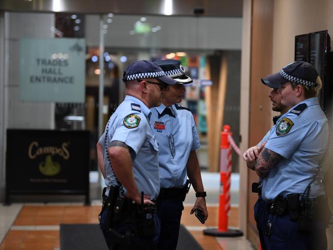 NSW Police guard the lobby of the Australian Workers' Union Sydney headquarters following a raid by the Australian Federal Police. Picture: AAP