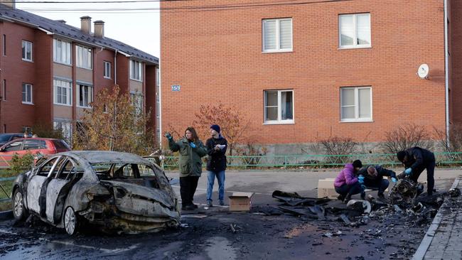 Russian law enforcement officers inspect the wreckage of a drone in the courtyard of residential buildings, following an attack in the village of Sofyino, Moscow, on November 10, 2024. Picture: AFP