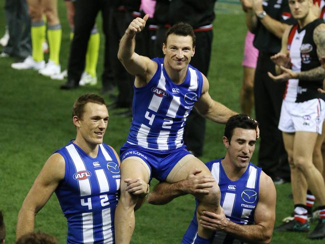 Brent Harvey is chaired off Etihad Stadium. Picture: George Salpigtidis