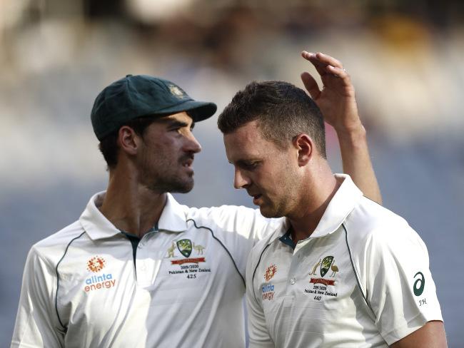 Josh Hazlewood is consoled by teammate Mitchell Starc as he leaves the ground. Picture: Getty