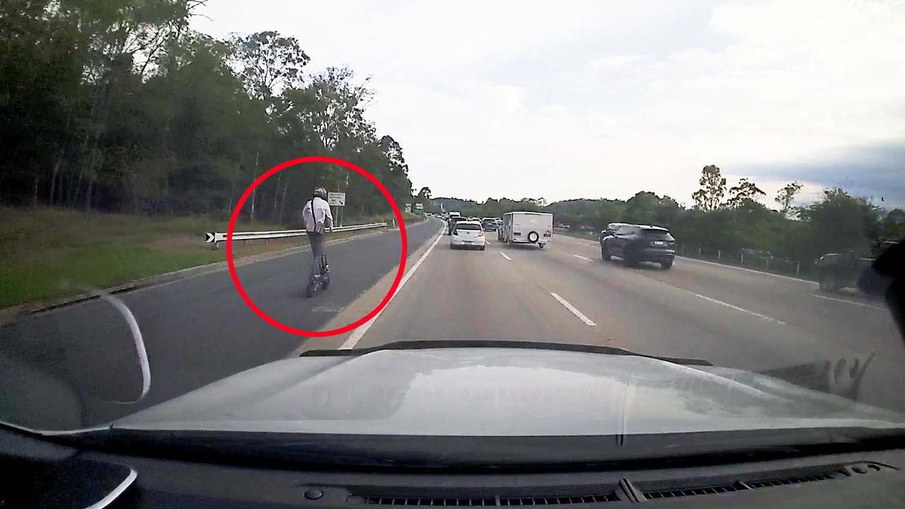 A man seen riding an escooter on the M1 in Helensvale on Friday December 1, 2023. Picture: Mark Boothman MP.