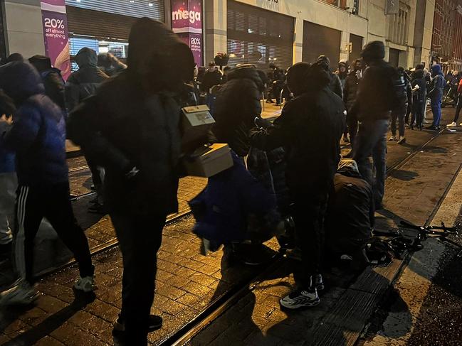 Protesters sort through looted goods in Dublin. Picture: AFP