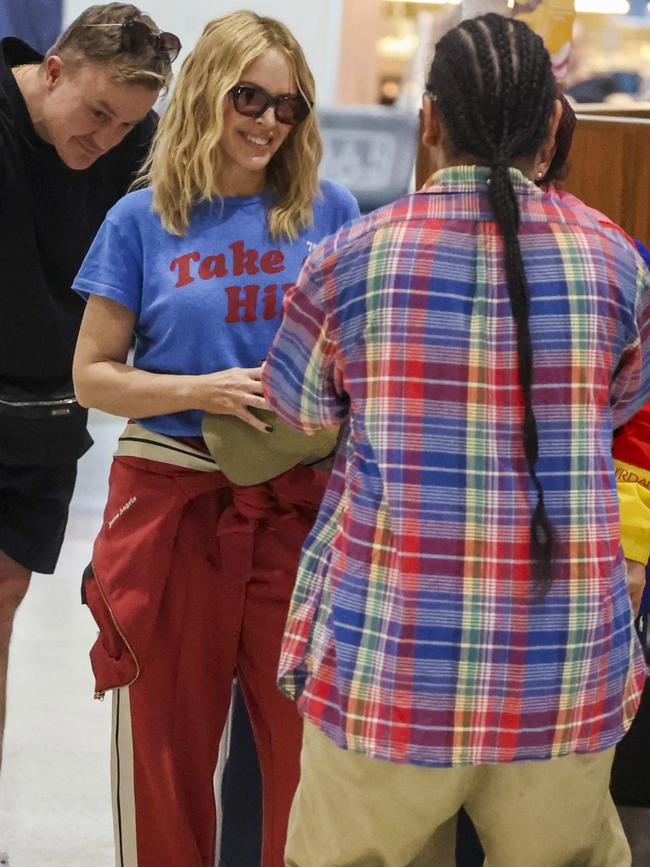 Minogue posed for photos with fans at Sydney Airport. Picture: Media Mode