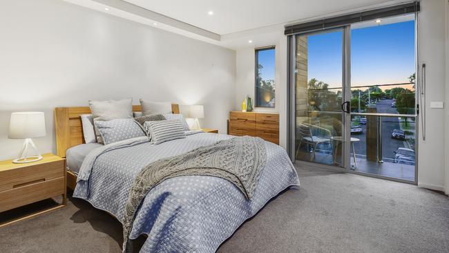 This first floor bedroom has a balcony with neighbourhood views.