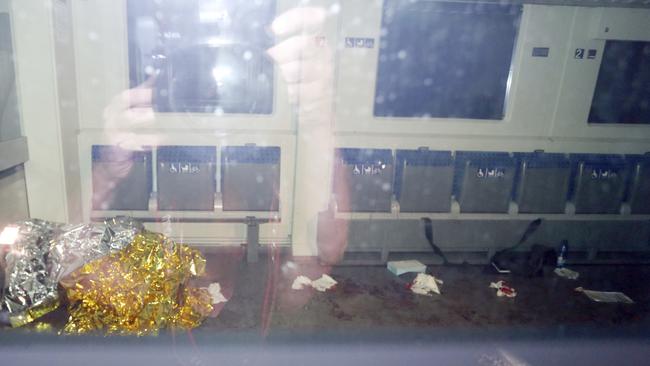 Blood stains and a rescue blanket are seen through the windows of a train in Wuerzburg, southern Germany. Picture: Karl-Josef Hildenbrand