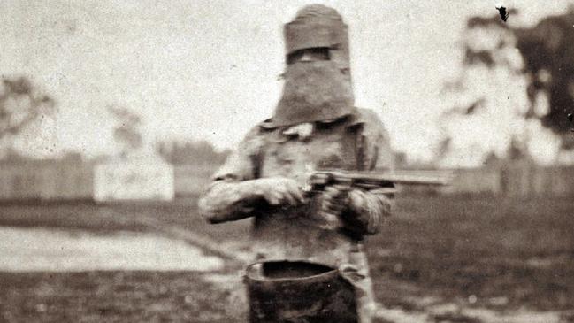 A policeman poses as Ned Kelly in his infamous “suit of armour” following Kelly’s capture. Kelly was eventually caught and hanged at Melbourne Gaol in 1880. Picture: AP/State Library of Victoria..