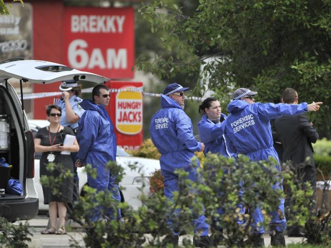 Forensic officers at the scene outside Hungry Jack’s on Cowpasture Road at West Hoxton. Picture: Robert Pozo