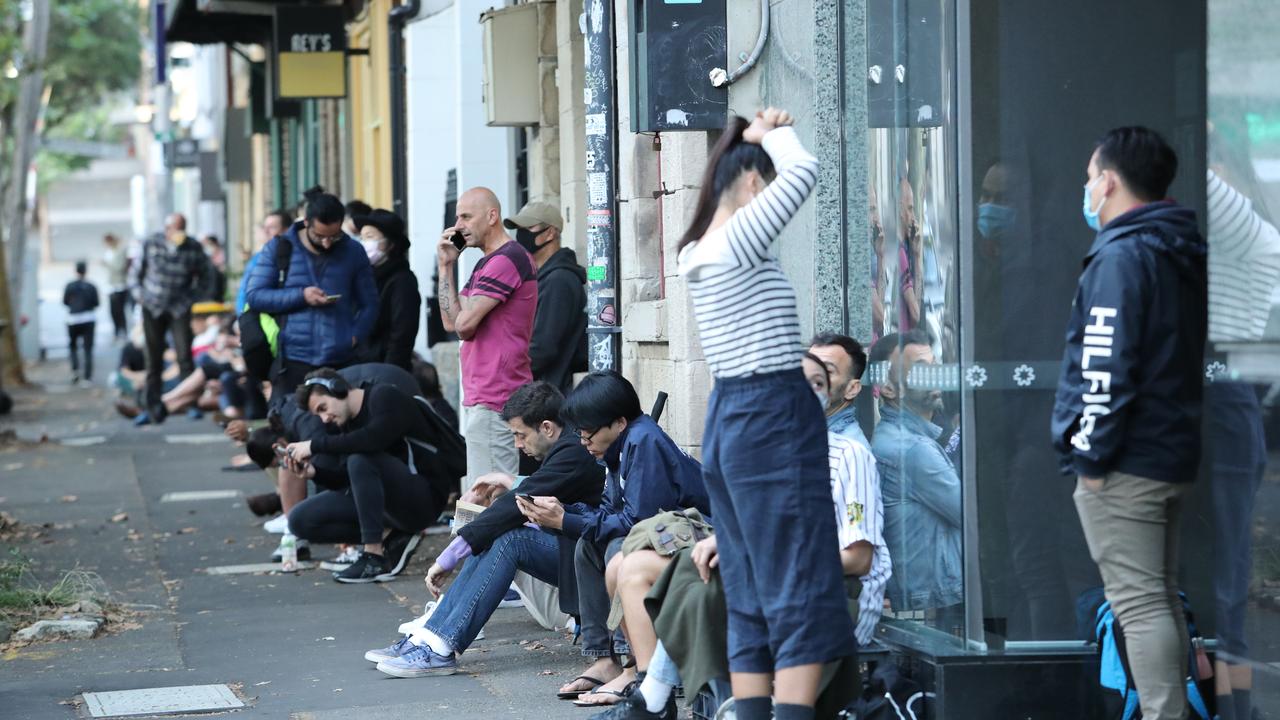 A queue forms outside the Darlinghurst Centrelink office yesterday morning, long before the office is due to open. Picture: Rohan Kelly