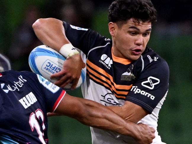 Brumbies' Noah Lolesio (R) is tackled by the Rebels' David Feliuai (L) during the Super Rugby match between the Melbourne Rebels and the ACT Brumbies in Melbourne on February 23, 2024. (Photo by William WEST / AFP) / -- IMAGE RESTRICTED TO EDITORIAL USE - STRICTLY NO COMMERCIAL USE --