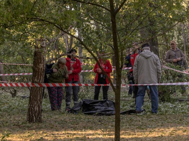 The grandmother is comforted by emergency services workers. Picture: Getty Images