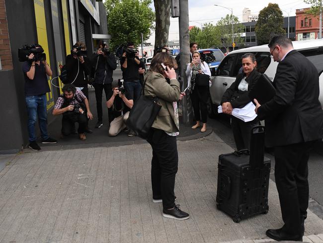 Media record federal police officers as they arrive at the offices of the Victorian brach of the AWU in west Melbourne. Picture: AAP