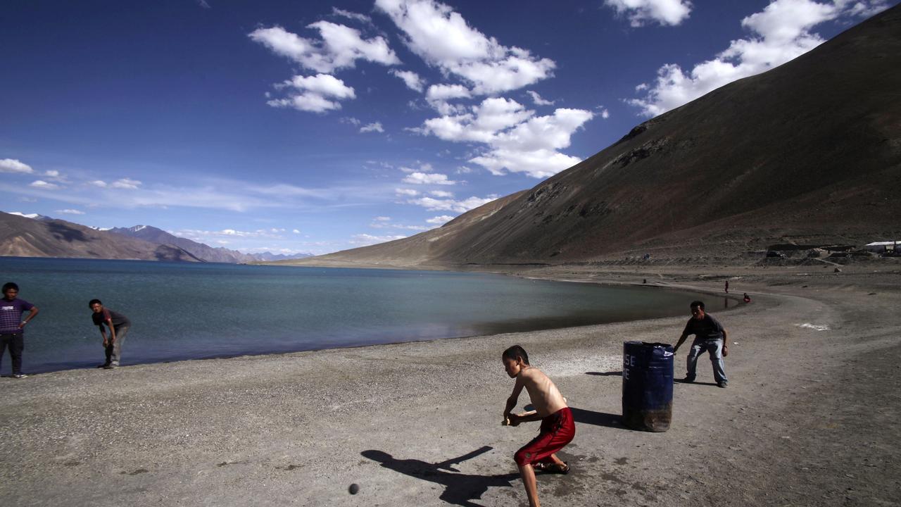 Children play cricket by Pangong Lake, near the India-China border in Ladakh, India. Picture: AP Photo/Channi Anand