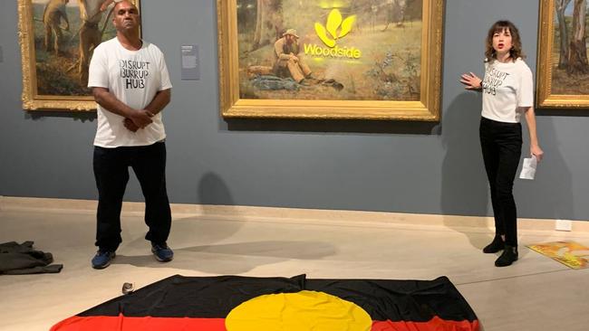 Joana Partyka (R) after defacing ‘Down on His Luck’ and gluing her hand to a wall at the Art Museum of Western Australia on January 19.