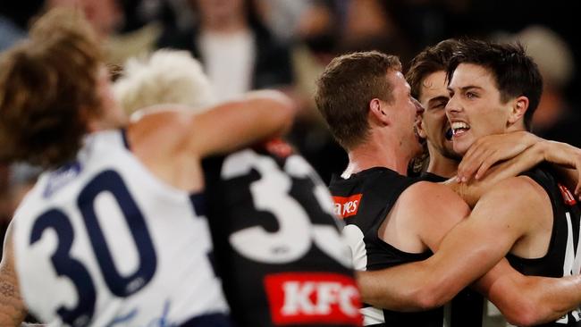 Oliver Henry celebrates a goal with Will Hoskin-Elliott and Josh Daicos. Picture: AFL Photos via Getty Images