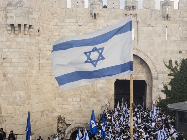 JERUSALEM, ISRAEL - MAY 18:  Ultranationalist Israeli jews hold the Israeli flag as they are marching in Jerusalem's old city muslim quarter on May 18, 2023 in Jerusalem, Israel. Israeli authorities will allow Orthodox Jews to parade through Jerusalem's Muslim Quarter in a decision that threatens to re-ignite violence in the holy city.  (Photo by Amir Levy/Getty Images)