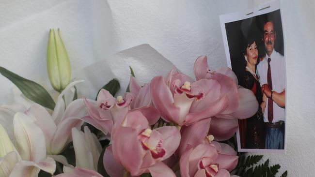 A photograph of Voula attached to a wreath of flowers laid outside the North Hobart Grocers by her children Picture: LUKE BOWDEN