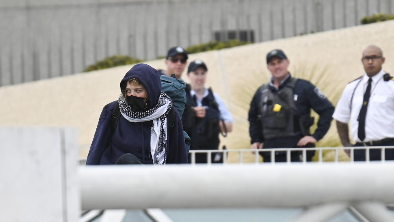 Pro-Palestinian protesters were arrested about 90 minutes after they breached security to unfurl a banner from the roof of Parliament House. Picture: NewsWire / Martin Ollman