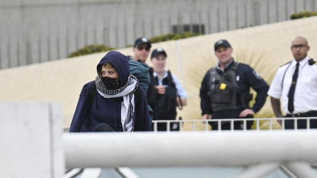 Pro-Palestinian protesters were arrested about 90 minutes after they breached security to unfurl a banner from the roof of Parliament House. Picture: NewsWire / Martin Ollman