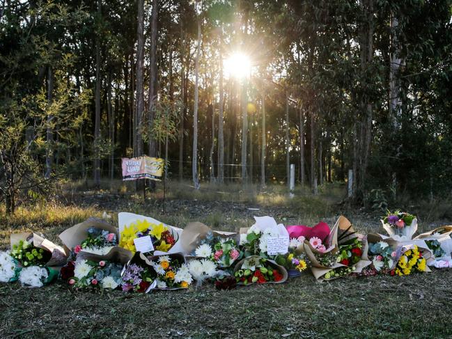 CESSNOCK, AUSTRALIA - JUNE 13: Floral tributes lie next to a road near the site of a bus crash on June 13, 2023 in Cessnock, Australia. A horrific bus crash in the Hunter Valley killed at least 10 and left some 25 people injured on Sunday night, New South Wales Police said. The bus was carrying guests who attended a wedding in the Hunter Valley. (Photo by Roni Bintang/Getty Images)