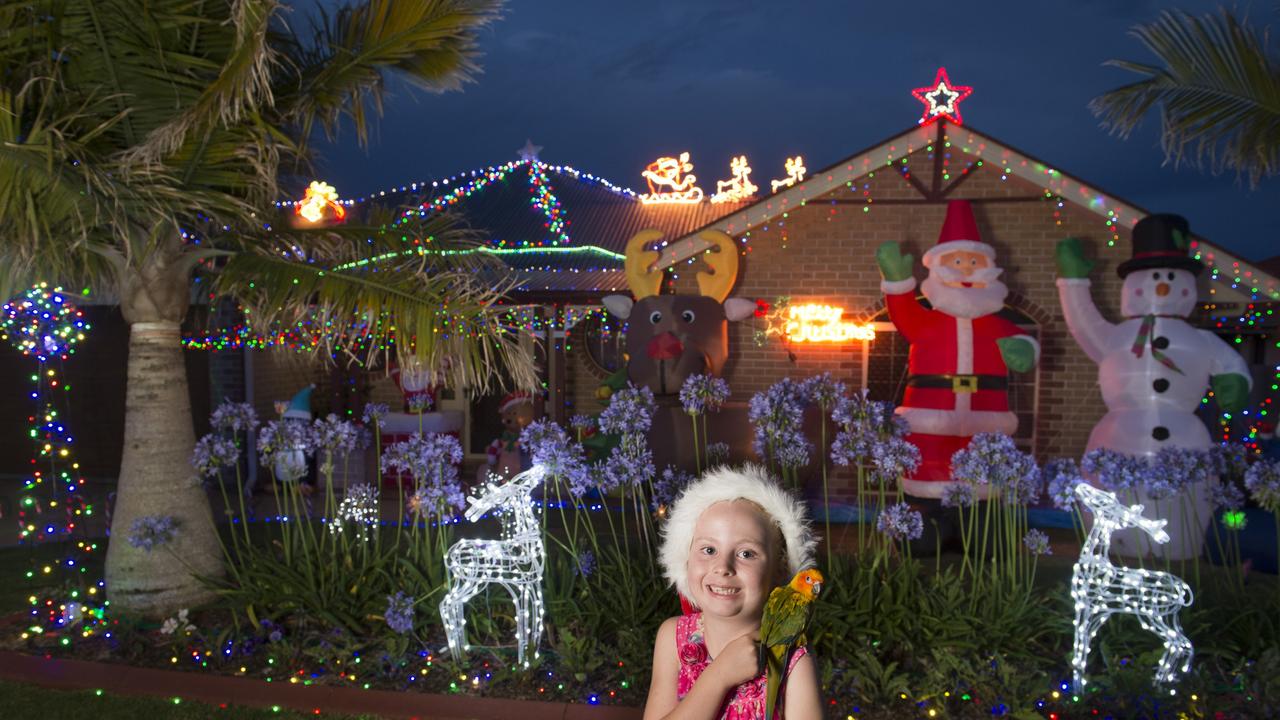 Zahli Eade with her sun conure parrot Binky outside her family's Prime Minister Dr home entered in the first time entered category of Toowoomba Christmas Lights Competition, Friday, December 11, 2015. Photo Kevin Farmer / The Chronicle