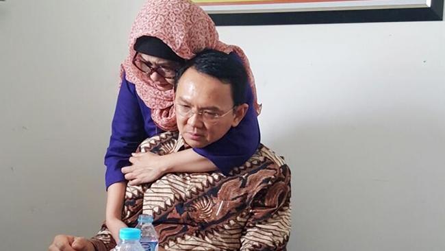 Adoptive sister Nana Riwayatie comforts Jakarta Governor Basuki Tjahaja Purnama at the start of his trial on Tuesday. Picture: Amanda Hodge