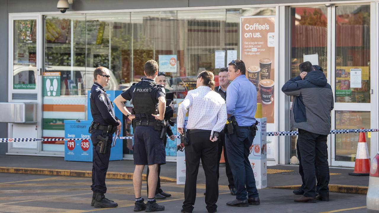 Police at the scene of a reported stabbing at a Bridge St service station on Saturday. Picture: Nev Madsen.