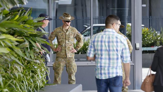 Police and Army personnel watch as Passengers arriving into Brisbane International Airport and forced into quarantine. Passengers getting off and being taken to buses before taken to hotels to quarantine, Sunday 29th March 2020 – Photo Steve Pohlner