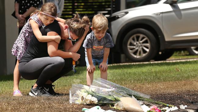 Hannah’s friend Lauren is comforted by her daughter, Mads, and son, Max, as they lay a floral tribute where the family was killed. Picture: Lyndon Mechielsen