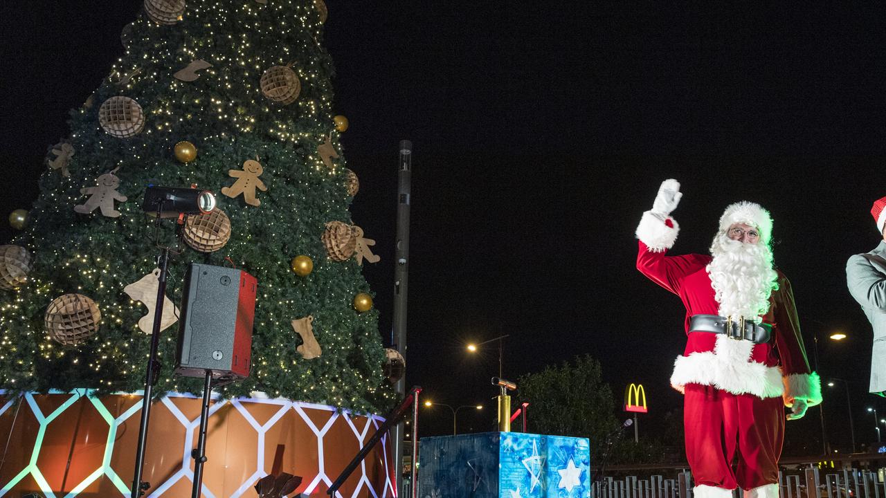 Santa waves to the crowd after pushing down the lever to light the tree at the CBD Christmas tree lighting event at Grand Central.