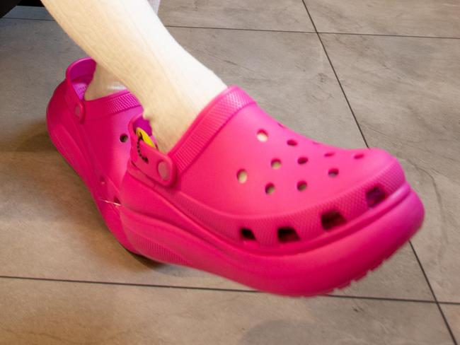 Crocs in high demand. Yiyi Zhang (7) tries on a pair at the Platypus store in Rundle Mall, Adelaide. November 27th 2023. Picture: Brett Hartwig