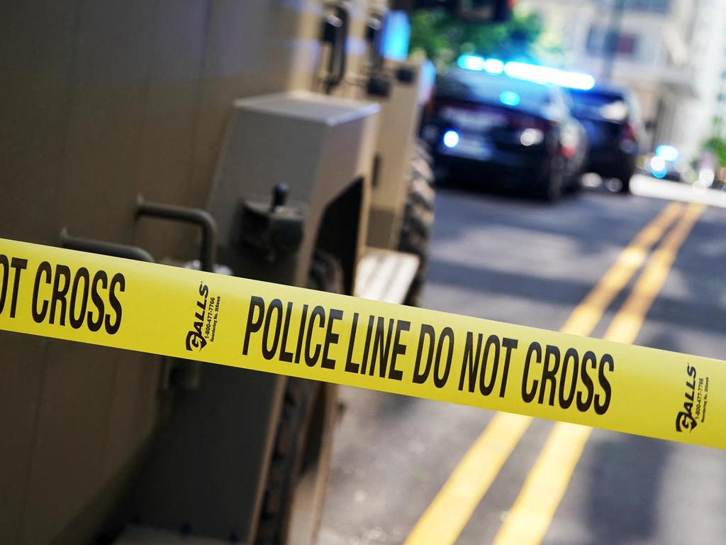 Police tape blocks off the area after a man shot four people in a building in Atlanta, Georgia, on May 3, 2023. (Photo by Elijah NOUVELAGE / AFP)