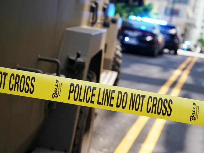 Police tape blocks off the area after a man shot four people in a building in Atlanta, Georgia, on May 3, 2023. (Photo by Elijah NOUVELAGE / AFP)