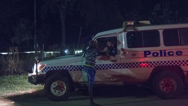 Policing is around the clock in a bid to curb the violence. Here an officer talks to a local who is on the streets after dark. Pic: Brian Cassey