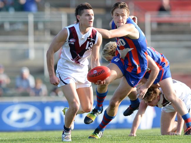 Sandringham Dragons player Luke Gogis is chased by Darcy Moore in 2014. Picture: Lawrence Pinder