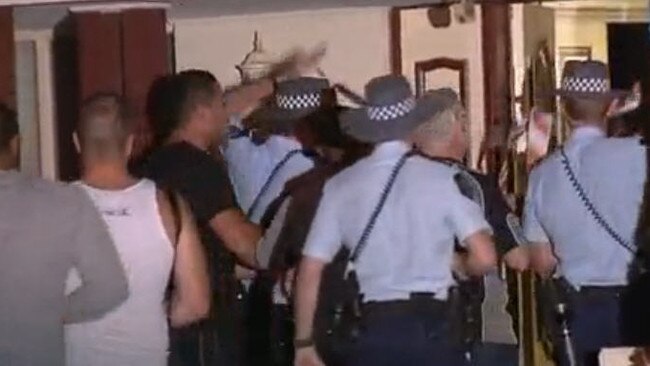 Musa Alzuain (pictured in black shirt) and police at the Alzuain family home in Parafield Gardens, where a molotov cocktail was thrown inside on November 20, 2012. Picture: Channel 10